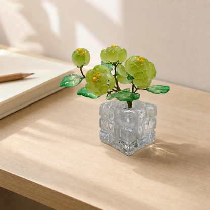 Spring green glass peony arrangement displayed on a desk