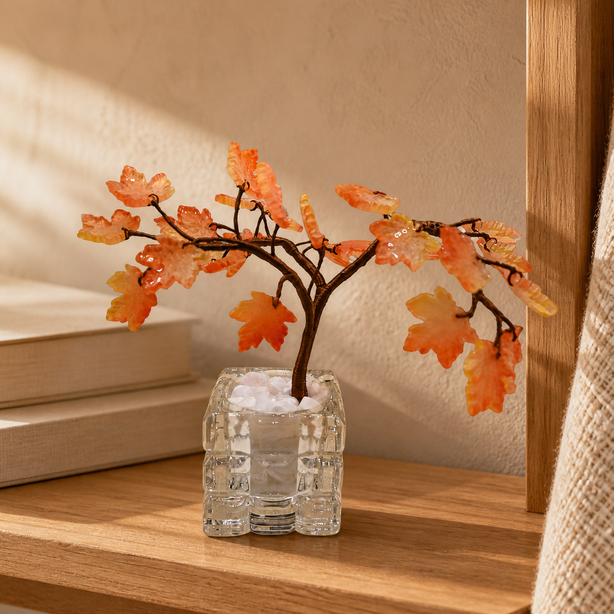 Amber glass maple tree displayed on a reading shelf