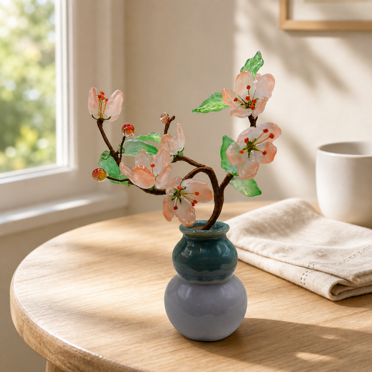 Blush glass peach blossom tree on a breakfast table