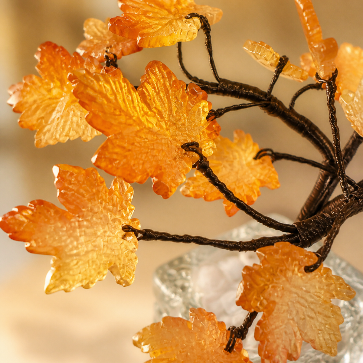 Close-up of translucent amber glass maple leaves