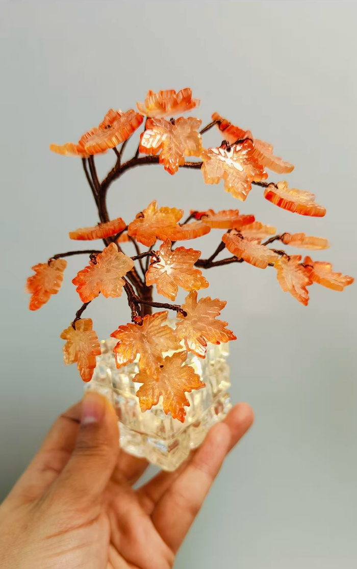 Handmade amber glass maple tree in a clear glass vase