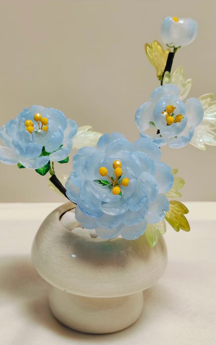 Handmade sky blue glass peony arrangement in a ceramic vase