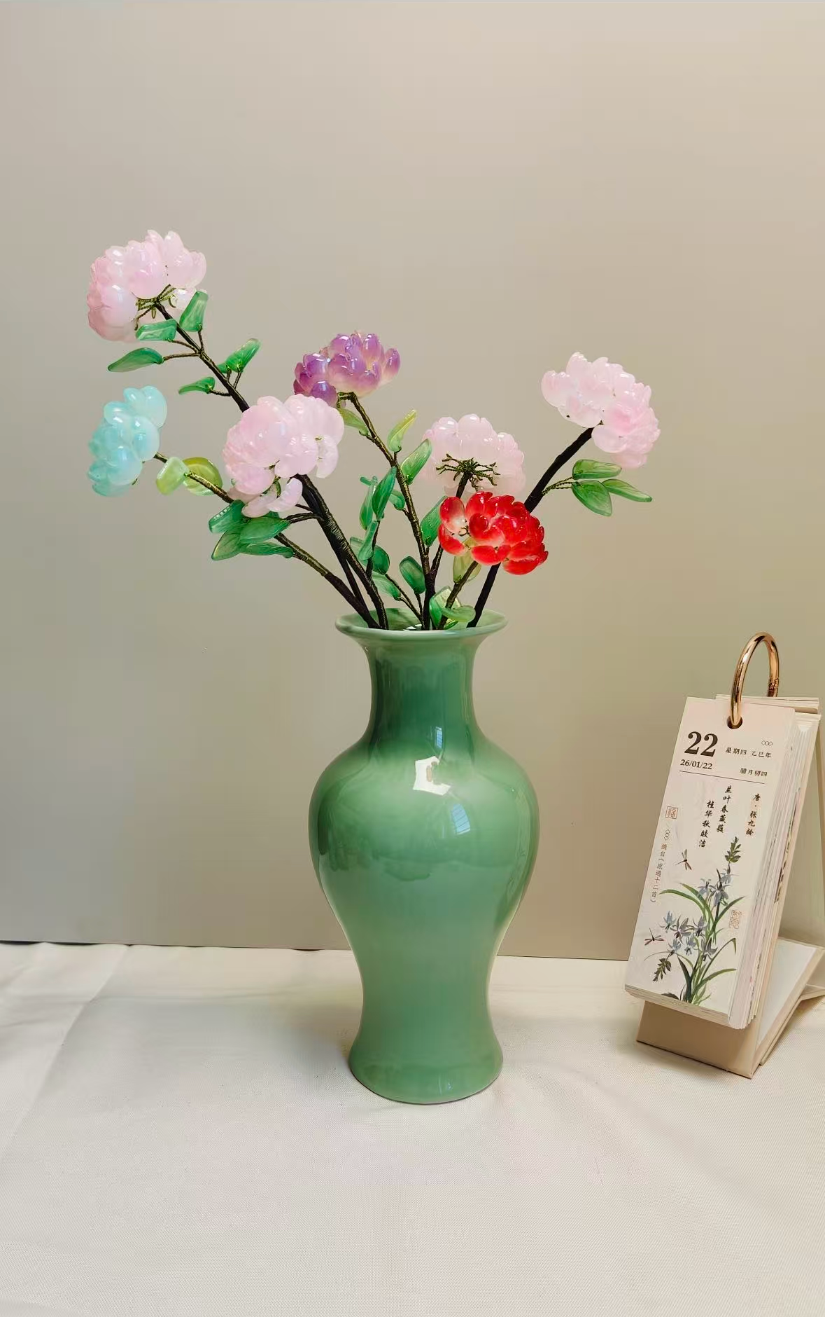 Multicolor handmade glass rose bouquet in a green ceramic vase