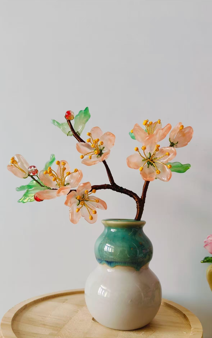 Handmade blush glass peach blossom tree in a ceramic vase
